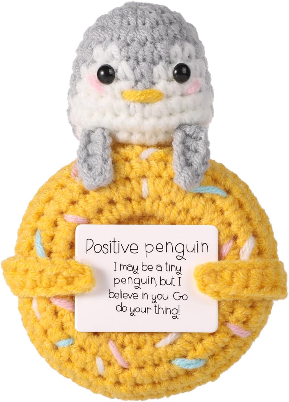 Positive penguin crochet character with yellow donut
