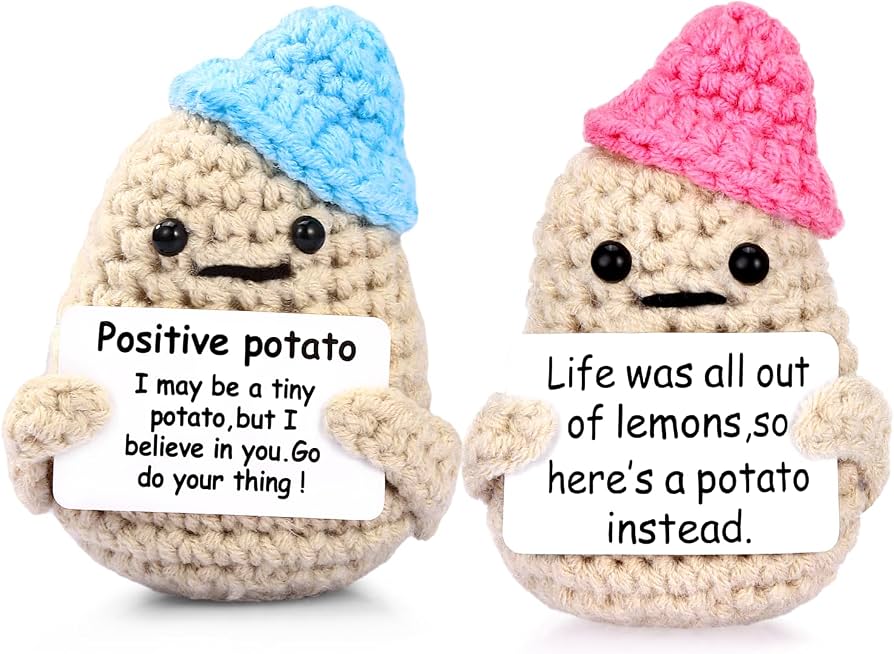 Positive crochet potato toys with blue and pink hats