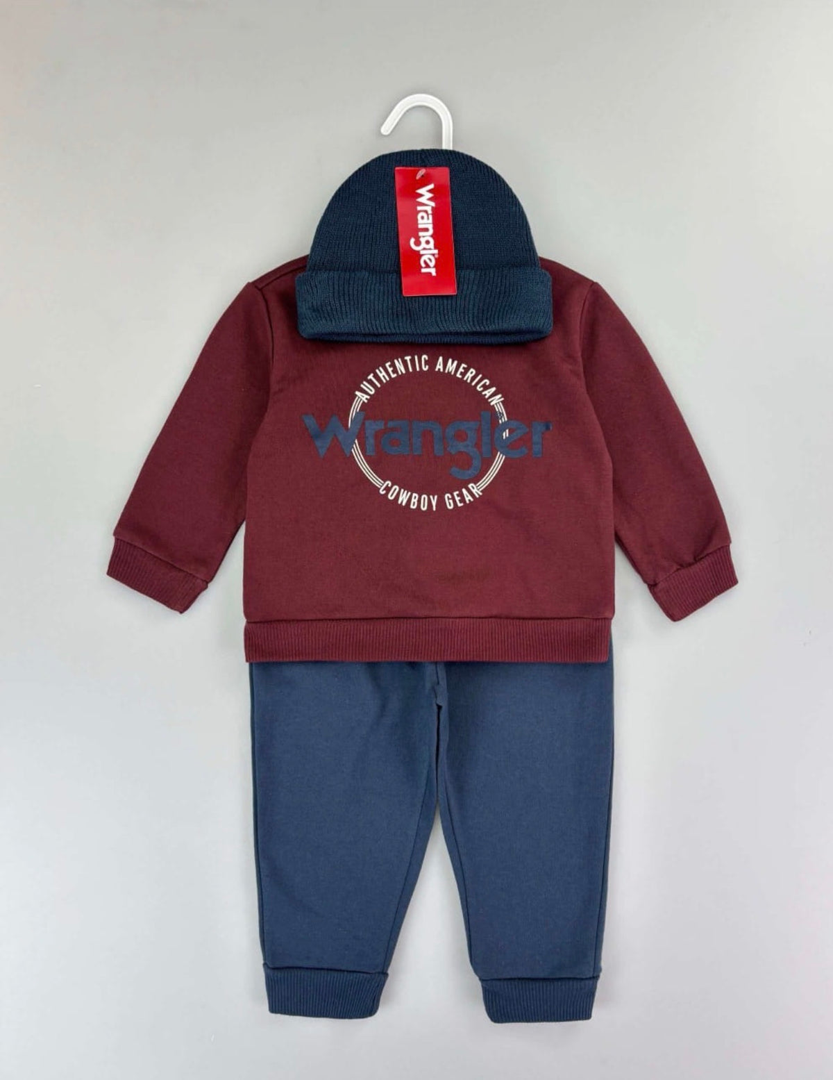 Authentic American Cowboy Gear print: burgundy Wrangler sweatshirt and blue trousers; beanie photographed
